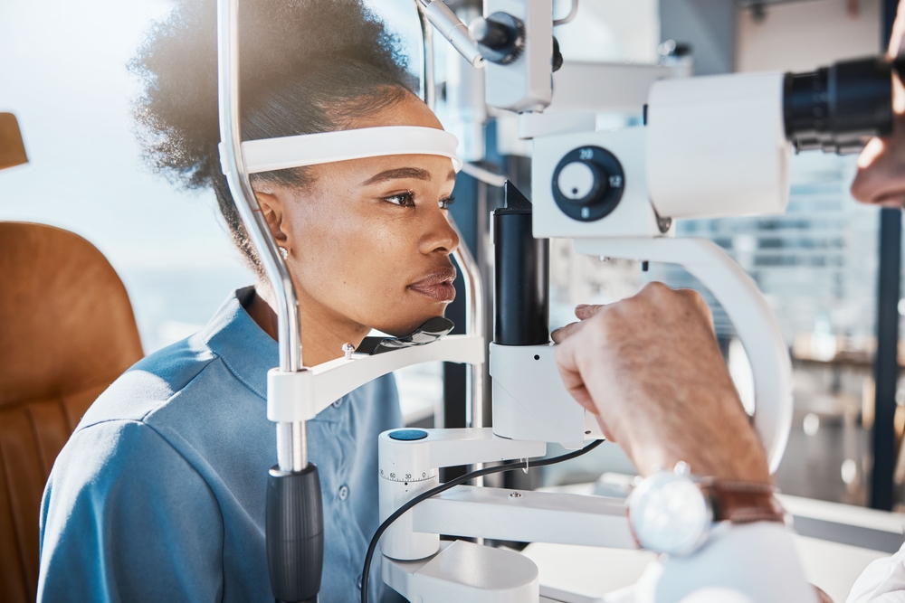 A woman undergoes an eye exam using a slit lamp at an optometrist's office - Optometrist Chapel Hill A woman undergoes an eye exam using a slit lamp at an optometrist's office - Optometrist Chapel Hill